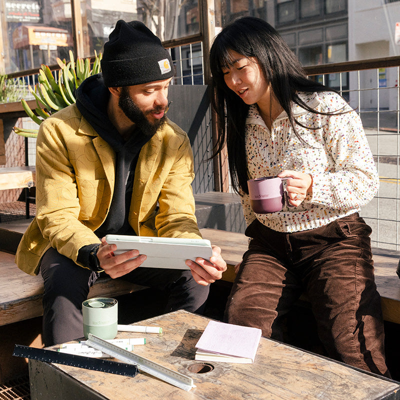 12oz-rise-mug-q2 12oz_rise_coffee_mug_dusty_orchid_couple_city_patio_square.jpg