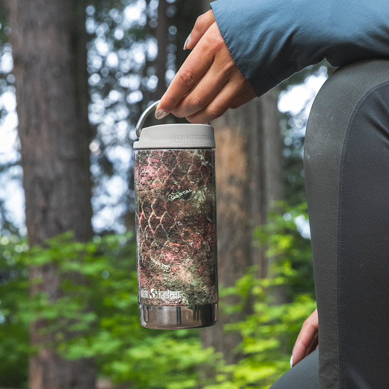 12oz-tkwide-with-twist-cap-mossy-oak-x9 12oz_tumbler_mossyoak_rainbowtrout_hand_closeup_square.jpg